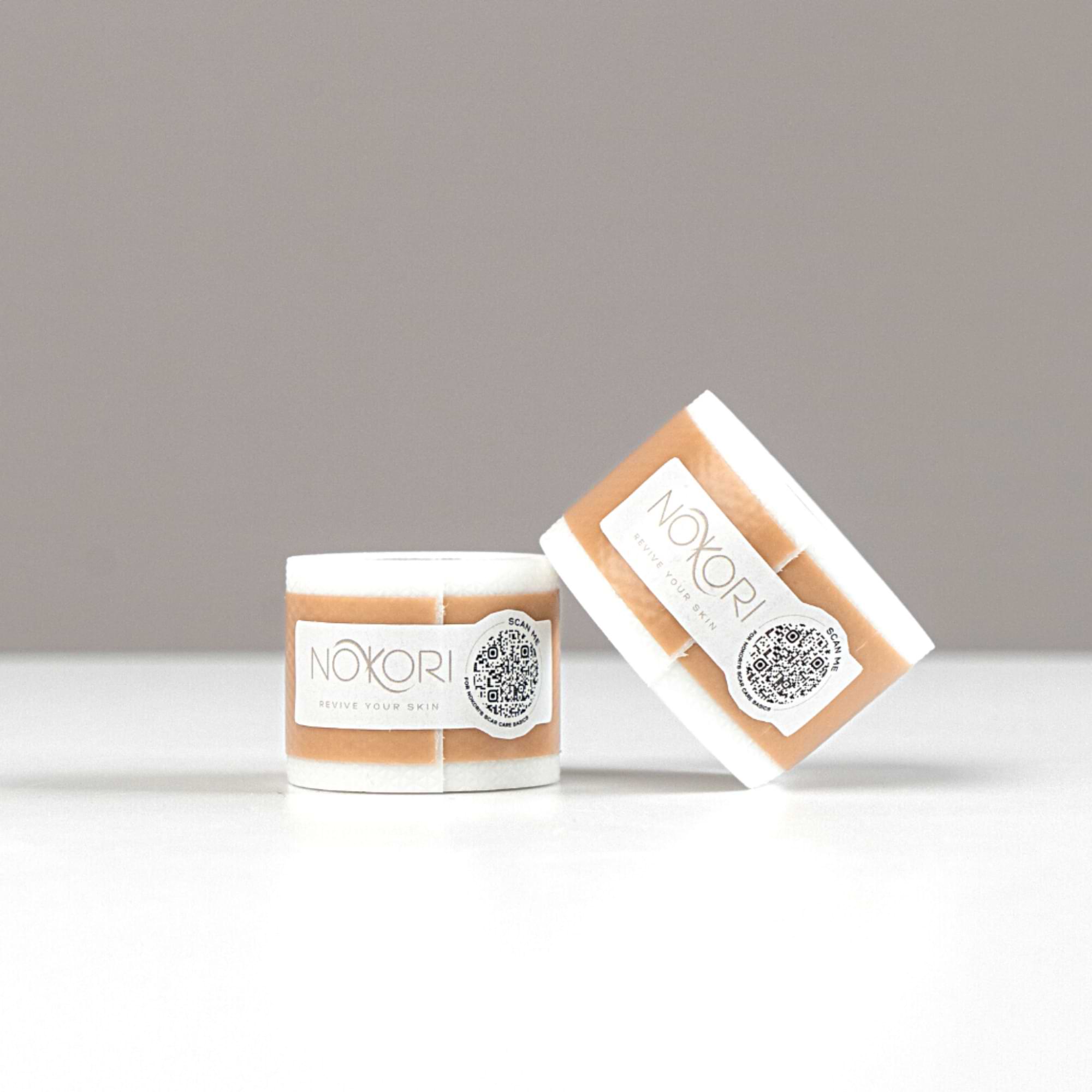 Nokori Scar Tape 300cm product with box and roll side by side on a light background, showing the label and silicone texture.