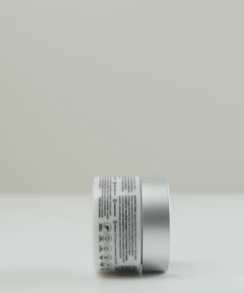Load video: Nokori Scar Balm jar rolling upright along a flat surface, showcasing the label and design.