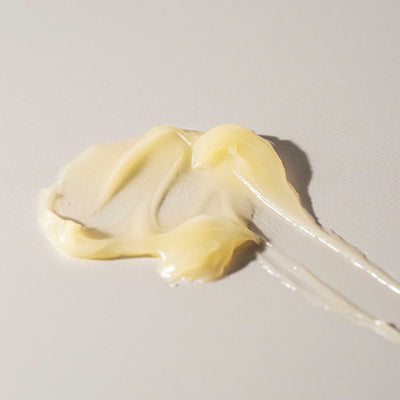 Close-up of Nokori Scar Balm texture swatched on a neutral surface, showing its rich, creamy consistency.